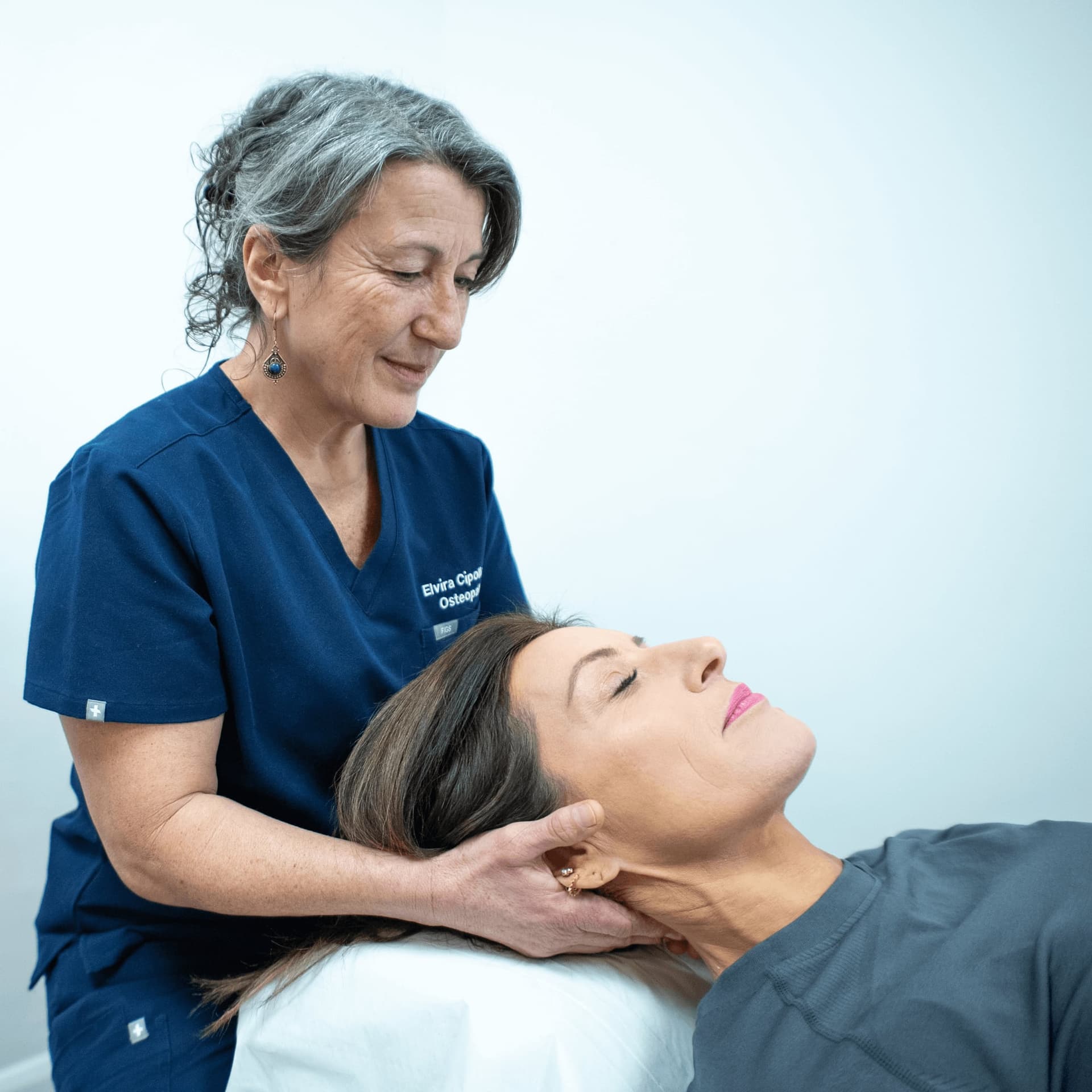 Physiotherapist performing neck therapy at an osteopathy and physiotherapy clinic