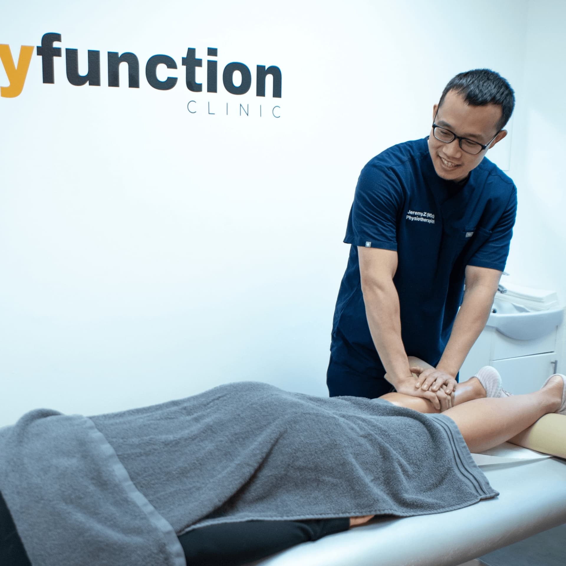 Therapist providing foot and ankle therapy at an osteopathy and physiotherapy clinic