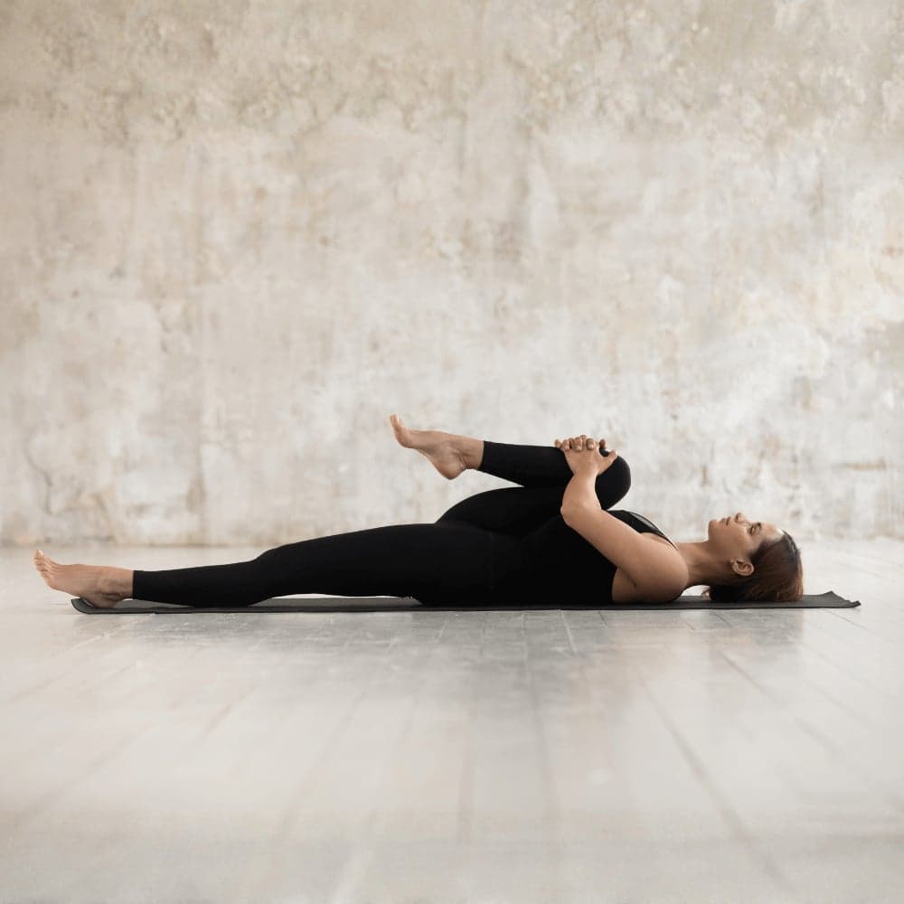 Physiotherapy knee to chest exercise used in back pain treatment