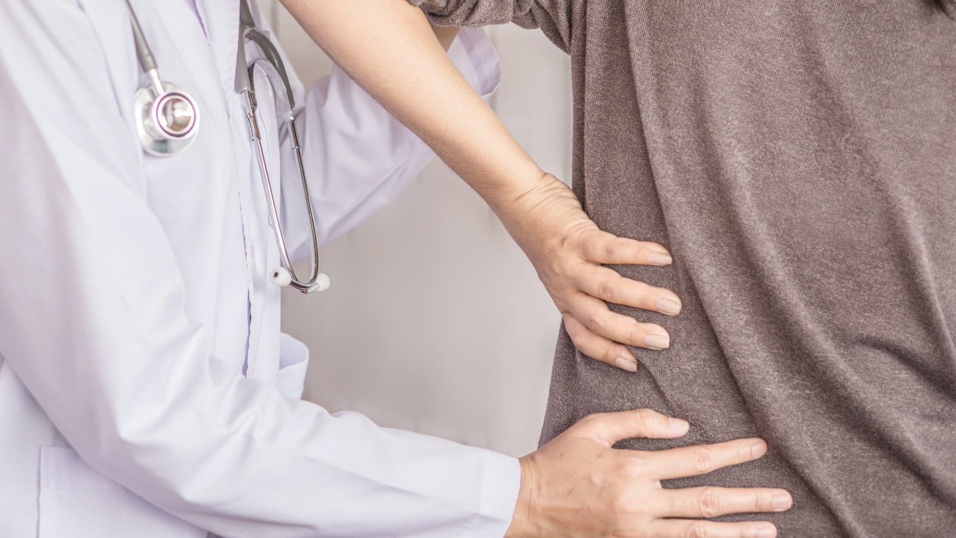 Osteopath assessing lower back and pelvis movement at Bodyfunction Clinic in Islington