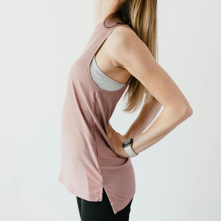 Standing lower back extension with the hands supporting the lower back